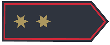 Schulterklappe in dunkelblauer Grundfarbe mit zwei sechszackigen Sternen in Gold, mittig in Reihe, Abzeichenumrandung in Rot